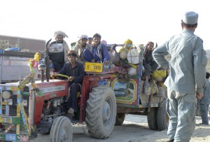 A tracktor and trailor with pashtun nomads, Kuchis, is waived through the check point near Gulridin by Afghan National Police 